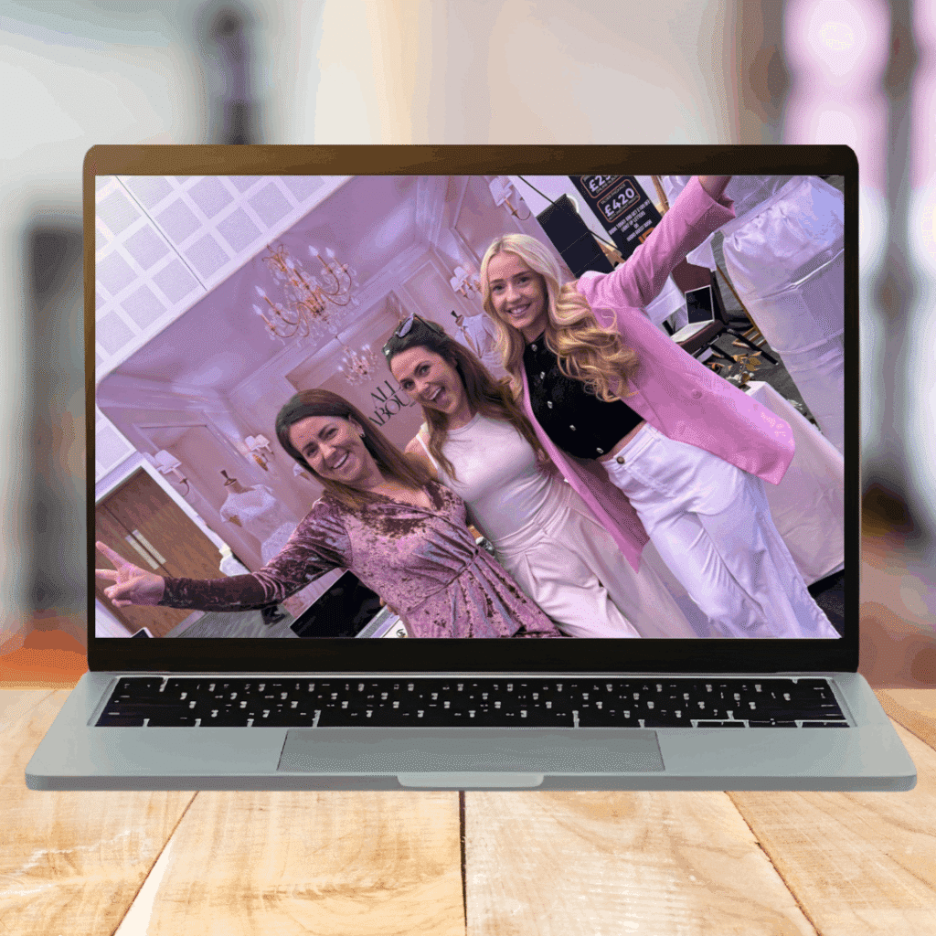 A laptop screen showing three members of the Creative Collins team using a pink theme